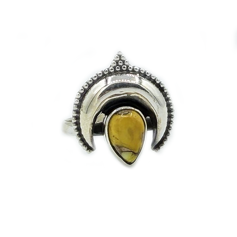 Silver ring with a yellow gemstone on a white background